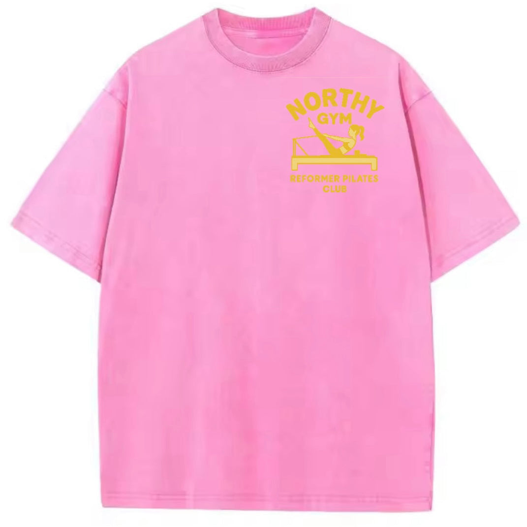 Pink t-shirt with yellow graphic and text on a white background