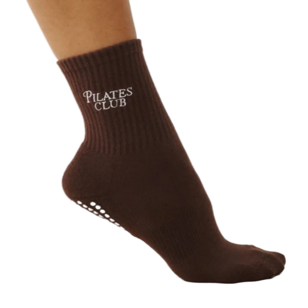 Brown Pilates Club sock on a beige background