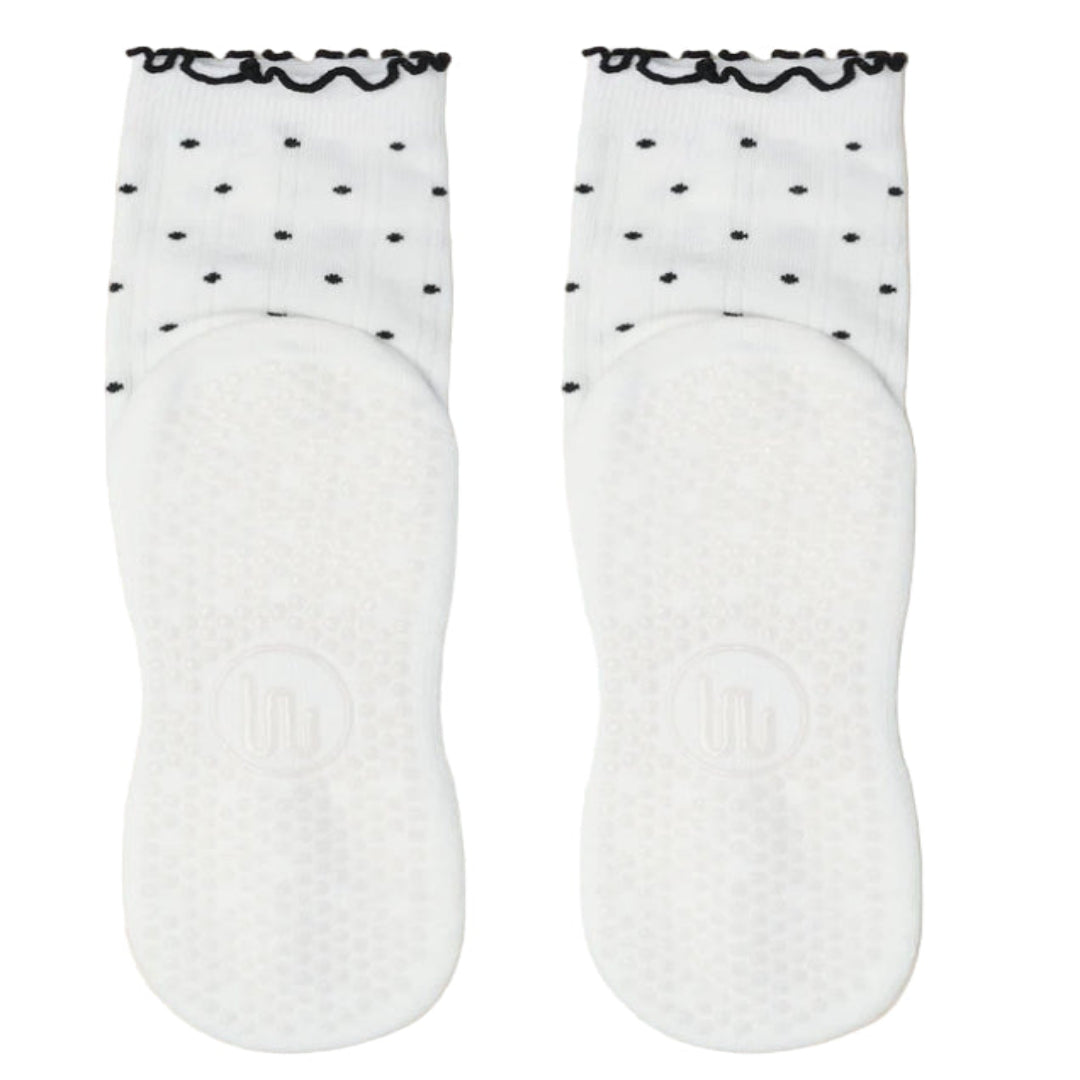 White socks with black polka dots on a white background