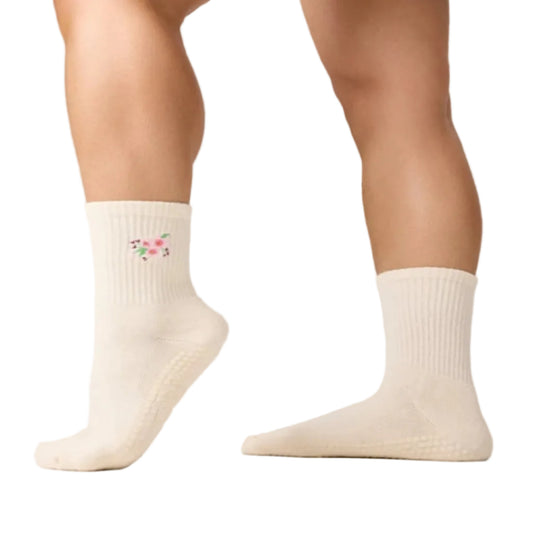 White socks with a floral design on a neutral background