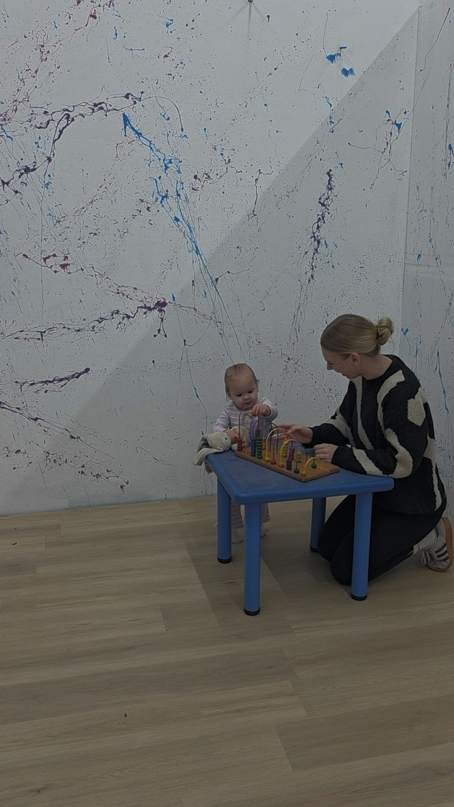A Northy crèche carer and child playing at an activity table